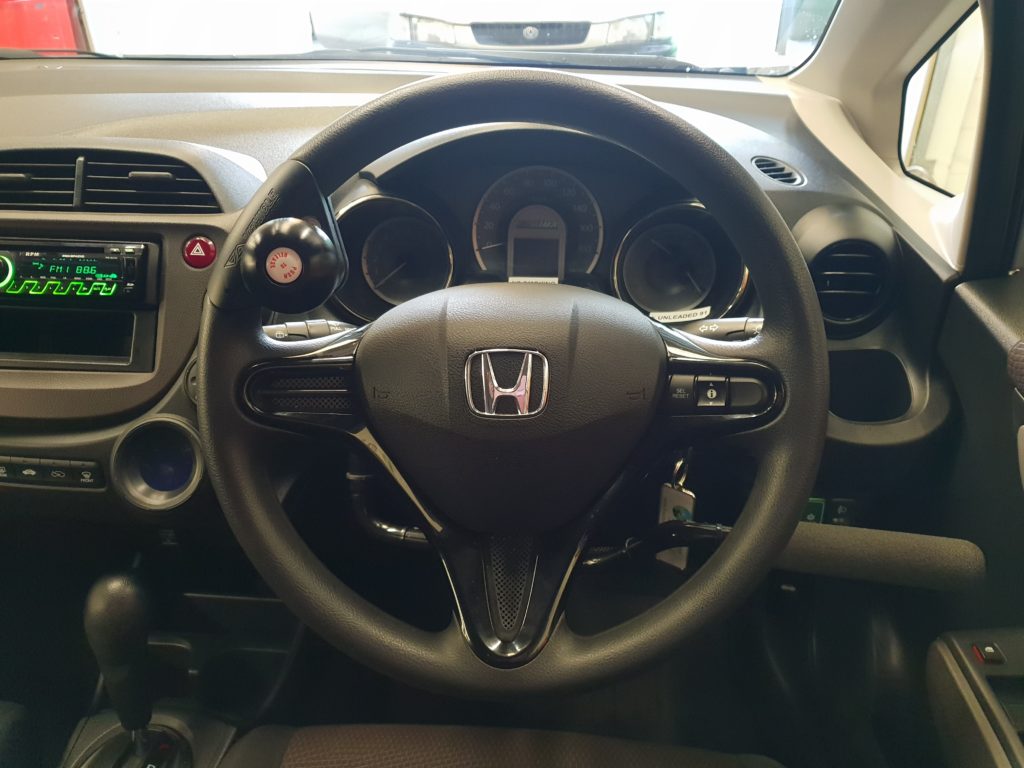 Hand controls of a Honda Fit Shuttle Hybrid Station Wagon for rent
