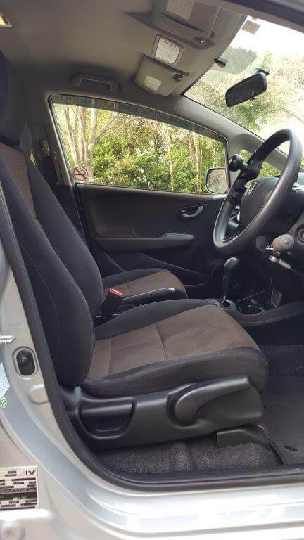 Interior of a Honda Fit Shuttle Hybrid Station Wagon with hand controls for hire